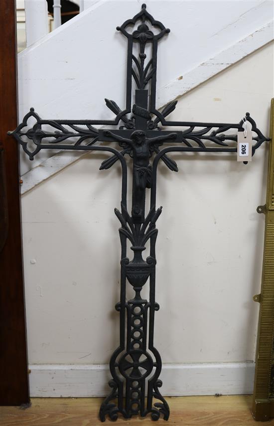 A cast iron black-painted crucifix of openwork foliate form length 104cm